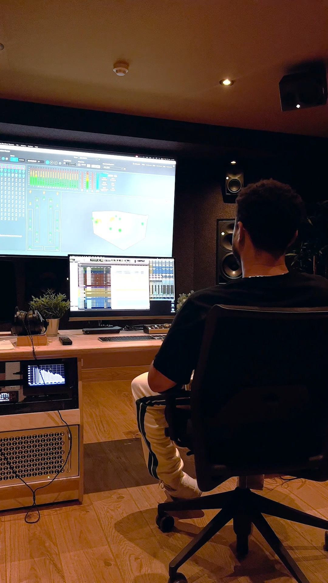 Jelani Blackman listening to one of his songs, mixed and mastered in Atmos.